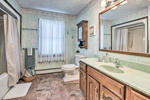 a bathroom with a sink and a toilet and a mirror at Charming Lewisburg Home with Hot Tub and Games! in Lewisburg