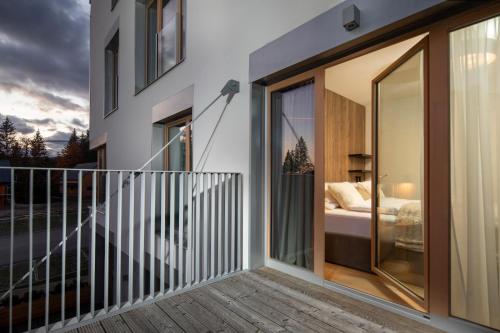 a balcony with sliding glass doors and a bedroom at Apartmán Hillside Panorama in Dolný Kubín
