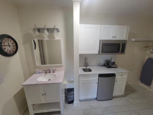 a white bathroom with a sink and a microwave at Circle Hotel Fairfield in Fairfield