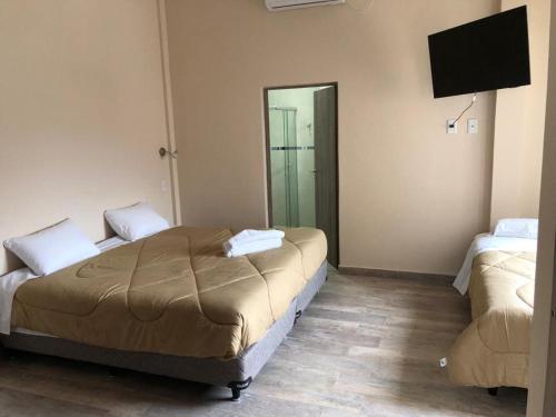 a bedroom with a bed and a flat screen tv at Edificio Itasu - 4to - alquileres temporales in Posadas