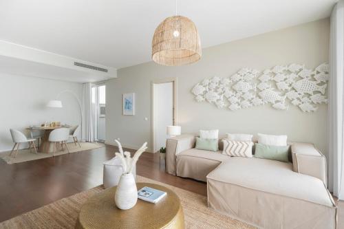 a living room with a couch and a table at Madeira Palace III by An Island Apart in Funchal