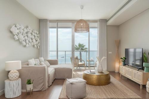 a living room with a couch and a tv at Madeira Palace III by An Island Apart in Funchal