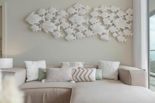 a white couch in a living room with a wall at Madeira Palace III by An Island Apart in Funchal