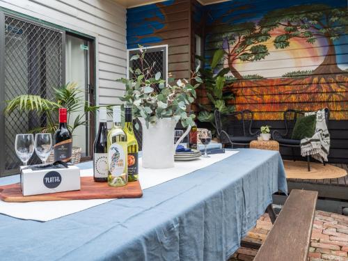a table with bottles of wine and wine glasses at Bendigo Backpackers in Bendigo