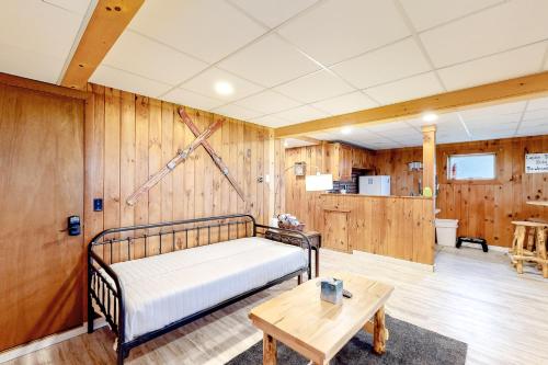 a bedroom with a bed and a wooden wall at Modern Log Chalet - Lower Unit in Montgomery