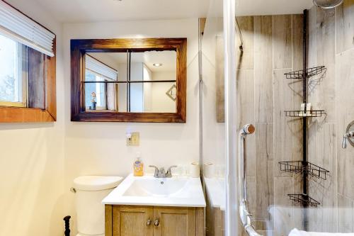a bathroom with a sink and a shower at Modern Log Chalet - Lower Unit in Montgomery