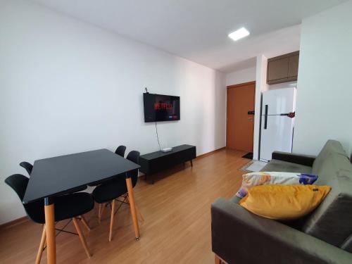 a living room with a couch and a table at Apto NOVO região Shopping Pantanal/Centro Político in Cuiabá