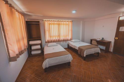 a hospital room with two beds and a television at EL MANÁ in Huarmey