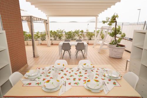 a table with chairs and a table cloth with flowers on it at Terrace Civitanova Life in Civitanova Marche