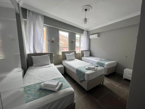 Postel nebo postele na pokoji v ubytování GRAND Deniz Hotel