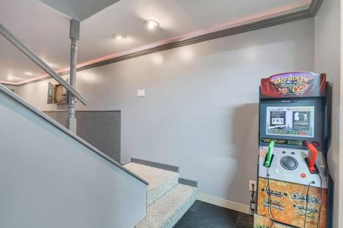 a video game machine in a room with stairs at Family Fun Getaway near Cascade Lake in Warwick NY in Warwick