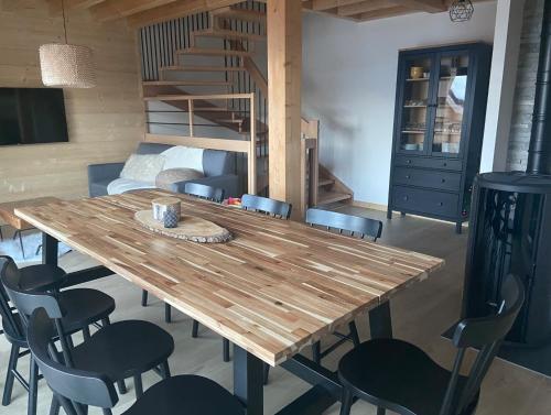 a dining room with a wooden table and chairs at Chalet L'Arguille in La Toussuire