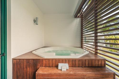 a bath tub in the corner of a bathroom at Go away to this charming apt at Sublime w private jacuzzi included in Las Terrenas