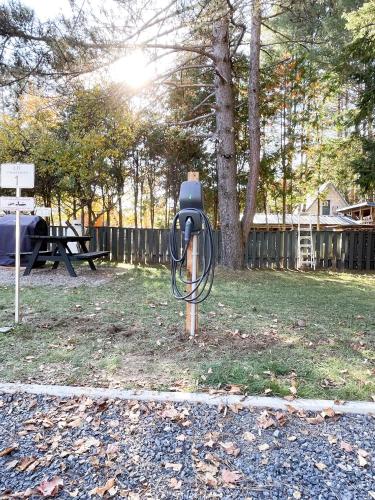 a parking meter sitting in the grass in a park at Complexe LIVTremblant by Gestion ELITE - LIV2 in Mont-Tremblant
