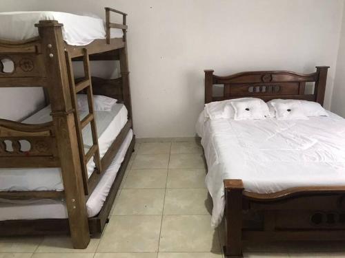 a bedroom with two bunk beds and a ladder at Donde Bris in Ríohacha