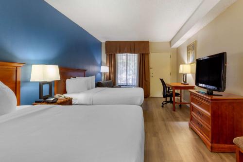 a hotel room with two beds and a flat screen tv at Best Western Plus Cary - NC State in Cary