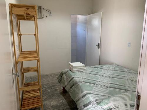 a bedroom with a ladder next to a bed at Chalés Solmar in Itapipoca