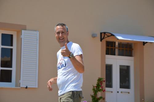 a man holding a baseball bat in front of a house at RE UMBERTO b&b - Suite di charme e Country rooms in San Salvo