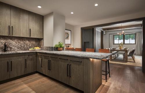 a kitchen with wooden cabinets and a dining room at Montage Big Sky in Big Sky