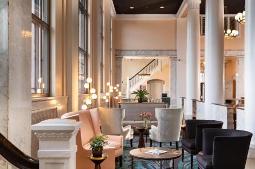 a lobby with chairs and tables in a building at The Liberty Trust in Roanoke