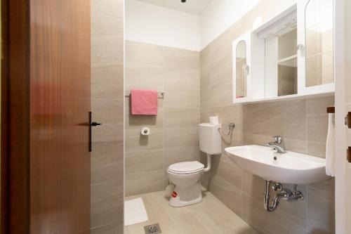 a bathroom with a toilet and a sink at Double Room Pasman 4309a in Pašman