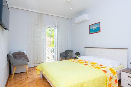 a bedroom with a large bed and a window at Rooms by the sea Pasman - 4309 in Pašman