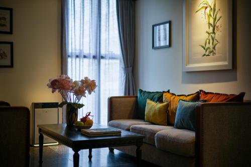 a living room with a couch and a coffee table at Amanaki Thao Dien in Ho Chi Minh City