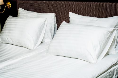 two white pillows sitting on top of a bed at Churchill-Inn in Vinnytsya