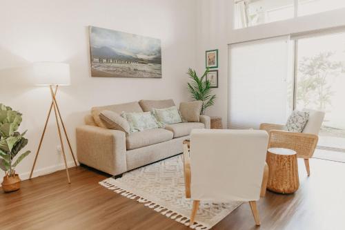 a living room with a couch and a table at Puamana Maluhia - Two Bedroom / Two Bath Condo in Princeville