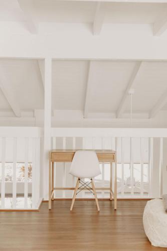 a desk and a white chair in a room at Puamana Maluhia - Two Bedroom / Two Bath Condo in Princeville