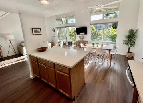 a kitchen and living room with a table and chairs at Puamana Maluhia - Two Bedroom / Two Bath Condo in Princeville