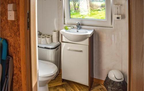 a small bathroom with a sink and a toilet at Awesome Home In Biskupiec With in Biskupiec