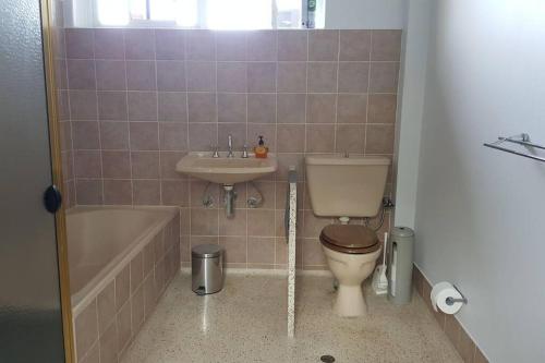 a bathroom with a toilet and a sink and a tub at Family Home Prestigious Suburb Panoramic Views in Glenunga
