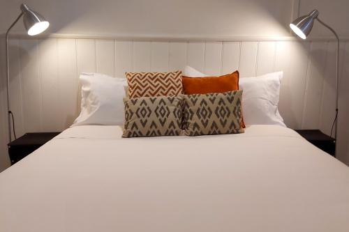 a white bed with pillows on top of it at Cara in Daylesford