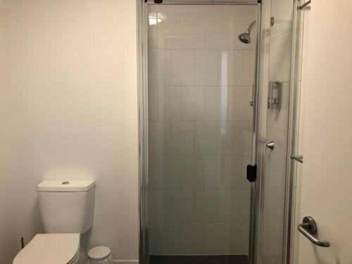 a bathroom with a toilet and a shower at Tindy’s City Pad in Adelaide