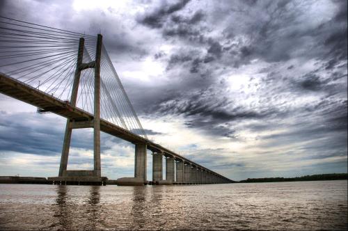 a bridge over a body of water with a cloudy sky at Monoambiente con Patio Exelente ubicación en el Centro in Rosario