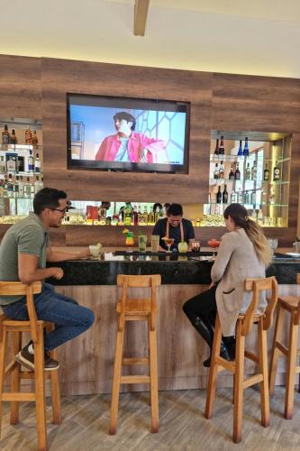 a group of people sitting at a bar at Inti Punku Valle Sagrado Hotel in Urubamba