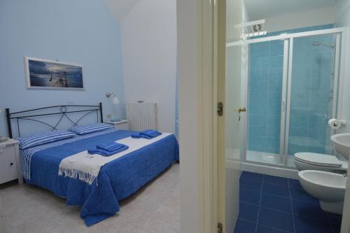 a bedroom with a bed and a bathroom with a sink at Bed & Breakfast Casalino in Triggiano