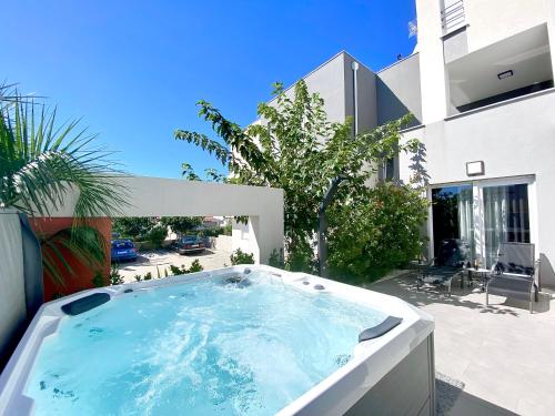 a hot tub in the backyard of a house at Fantasy View Villa in Novalja