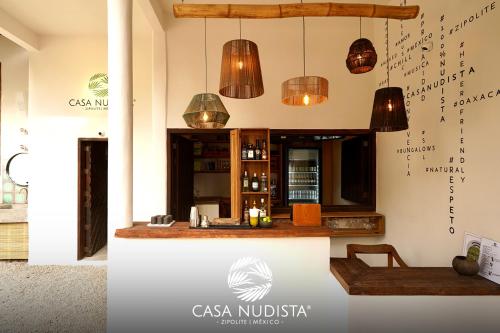 a kitchen with pendant lights and a counter at Casa Nudista - LGBT Hotel in Zipolite