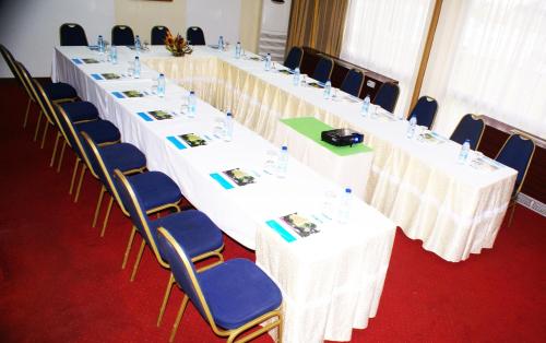 a row of tables and chairs in a room at Hôtel Sawa in Douala