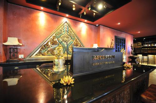 a bar with a sign on a wall at Siralanna Hotel in Patong Beach