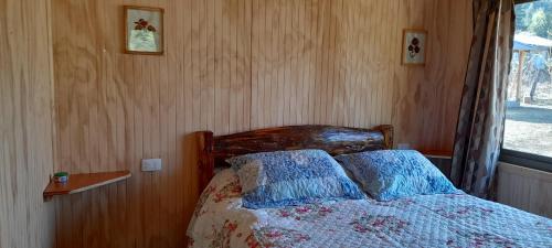 a bedroom with a bed with two pillows on it at José María in Melipeuco