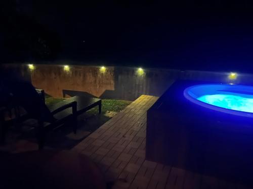 a jacuzzi tub in a backyard at night at Pine House in Ginoza in Ginoza