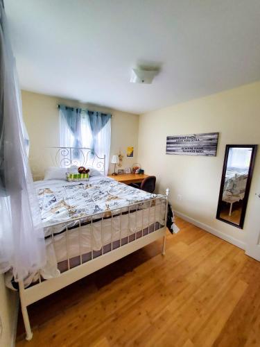 a bedroom with a bed and a wooden floor at 5 star Room2/Close to everything/5 min walk metro/Rockville Town Center in Rockville