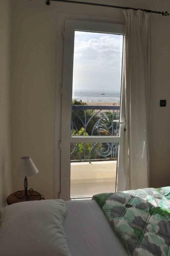 a bedroom with a bed and a view of the ocean at Résidence La Galiote in Essaouira