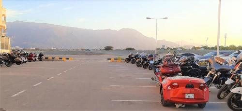 a row of motorcycles parked in a parking lot at Nizwa Hotel Apartments in Nizwa