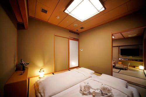 a bedroom with a large bed with a skylight at Radium Kagaya Taipei in Taipei