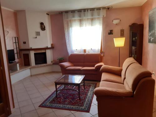 a living room with a couch and a coffee table at casa papillon in Sestino
