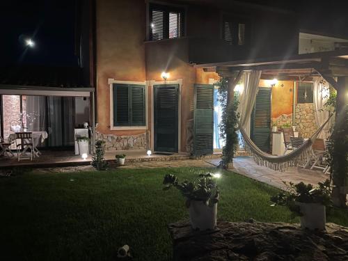 a house with a yard at night with lights at B&B Il Sentiero in San Sperate